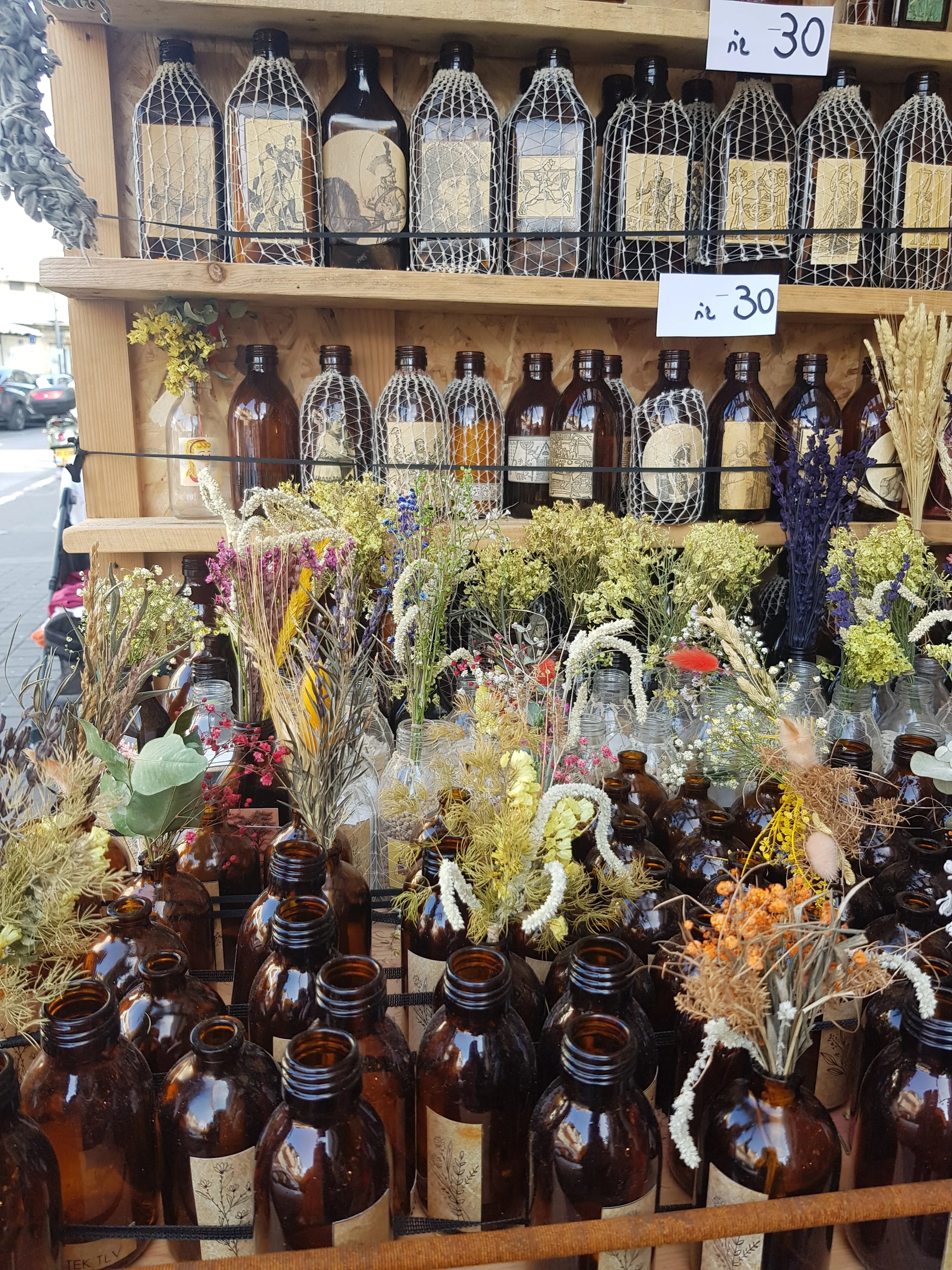 Dried flowers bouquet in a brown vintage glass bottle.