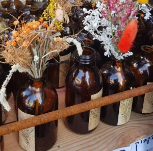 Dried flowers bouquet in a brown vintage glass bottle.