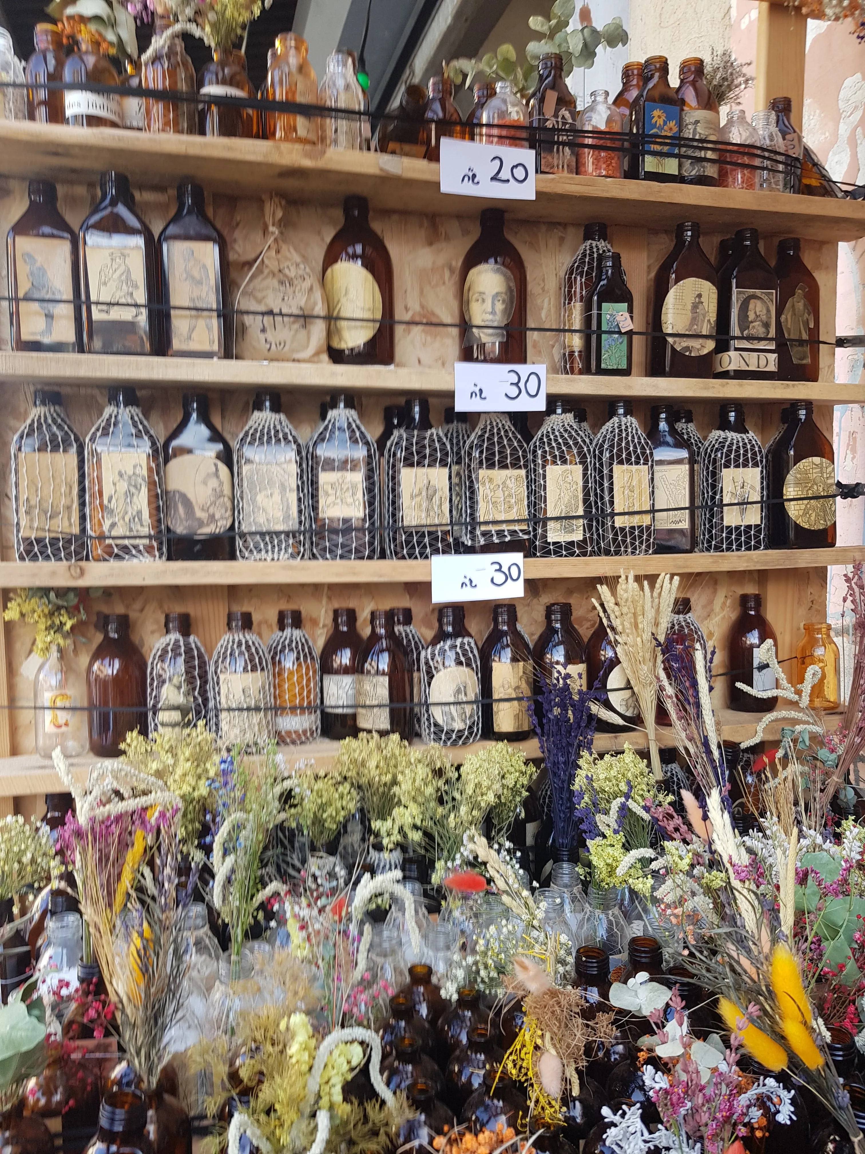 Dried flowers bouquet in a brown vintage glass bottle.